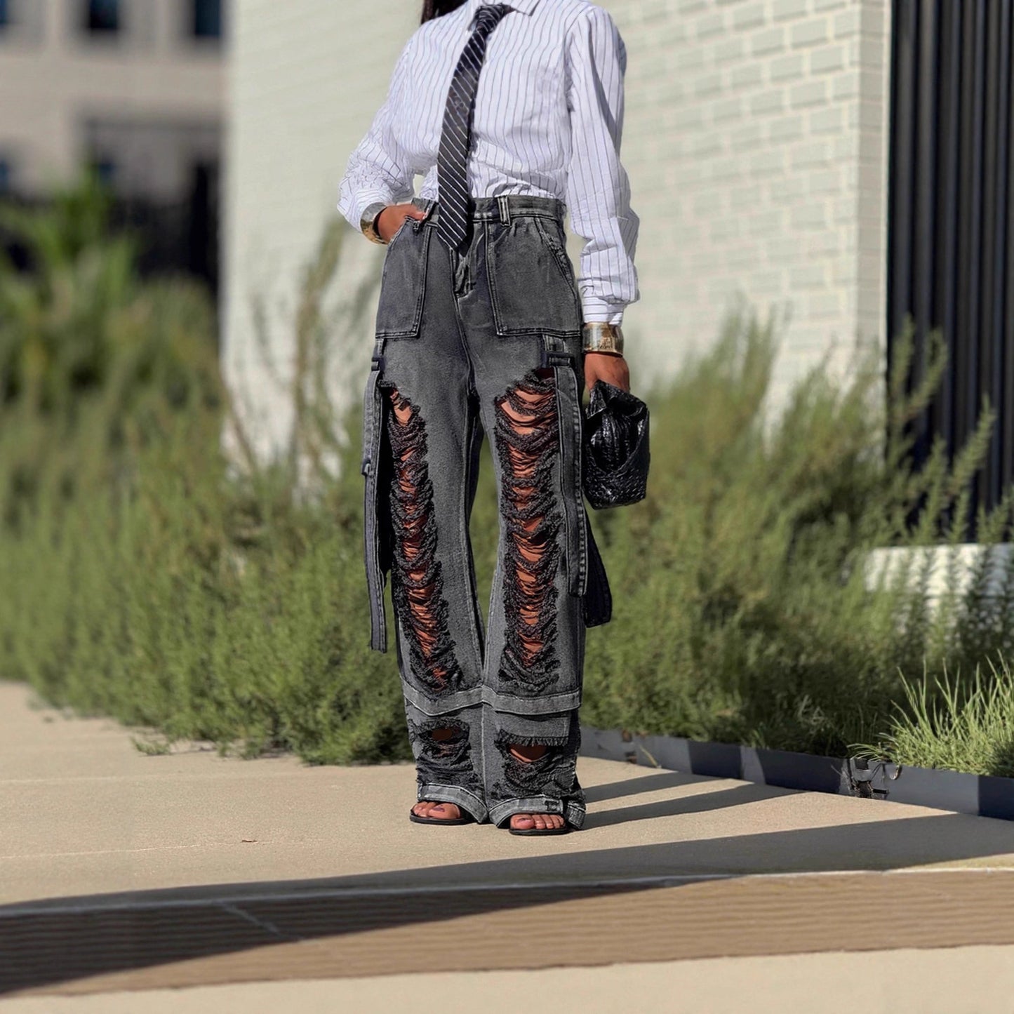 Eprolo ripped cargo jeans with tie details, featuring distressed fabric and multiple pockets for a rugged, casual look.