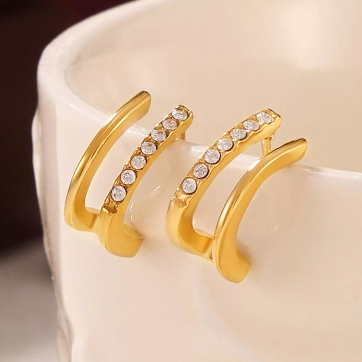 Gold-plated titanium steel rhinestone earrings with sparkling stones, stylish jewelry accessory from Plush Fashion Hub.