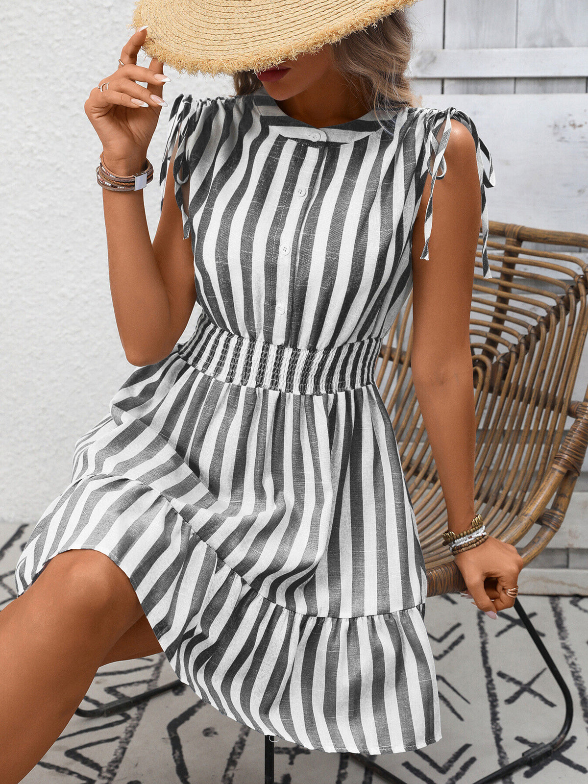 Women's striped smocked summer dress with ruffle hem from Plush Fashion Hub, featuring a fitted bodice and flowing skirt.