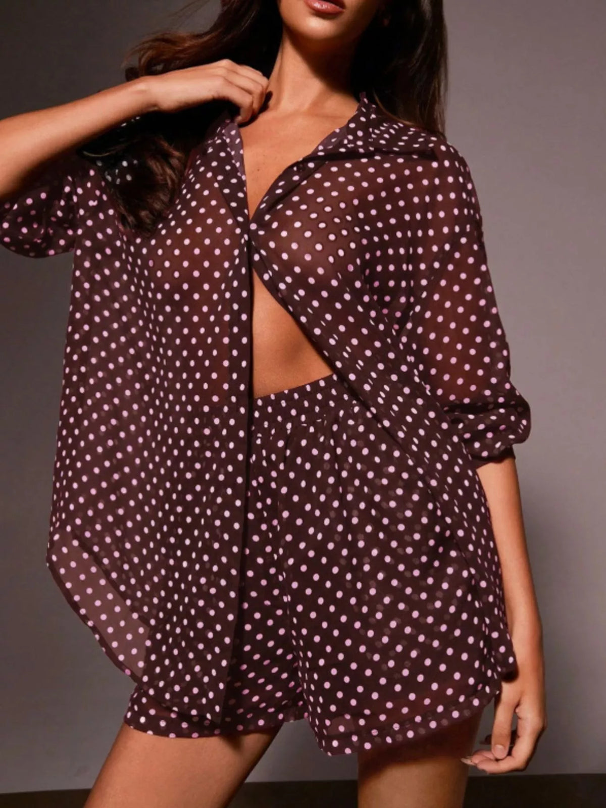 Polka dot button-up loungewear shirt and shorts set by Plush Fashion Hub, featuring a relaxed fit and playful pattern.