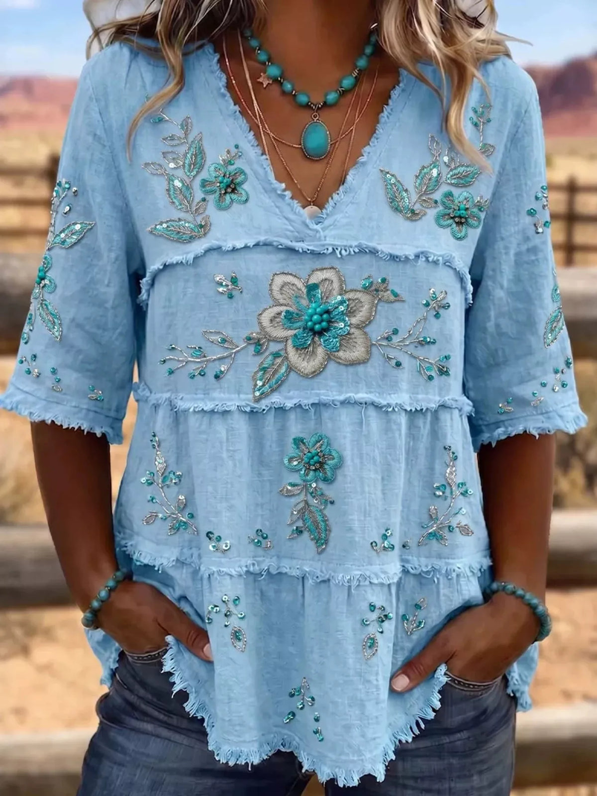 Plus size floral V-neck blouse with raw hem, full size shirt by Trendsi featuring a stylish floral pattern and relaxed fit.