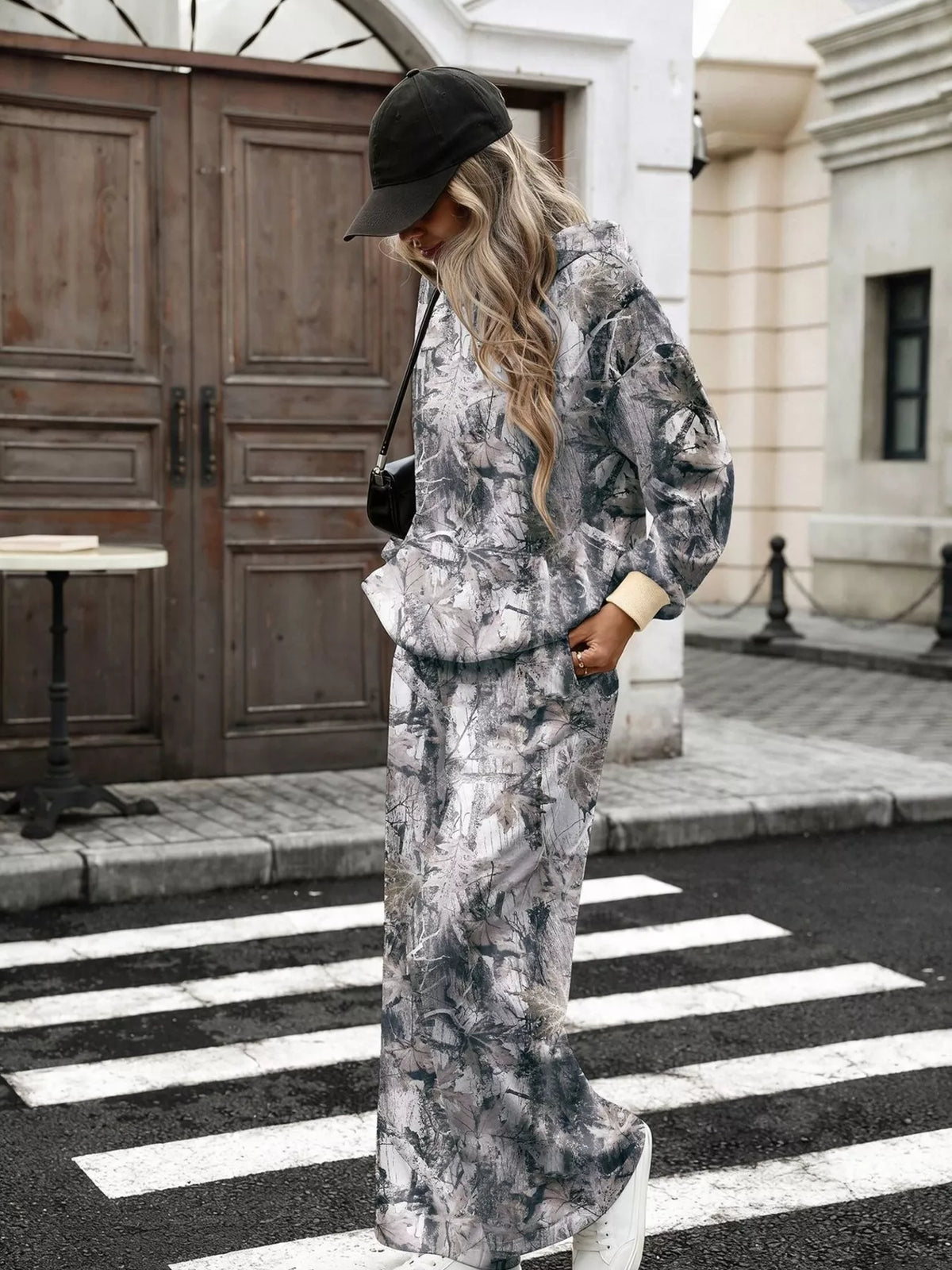 Printed long sleeve hoodie and pants set by Trendsi, featuring a stylish design and comfortable fit in matching fabric.