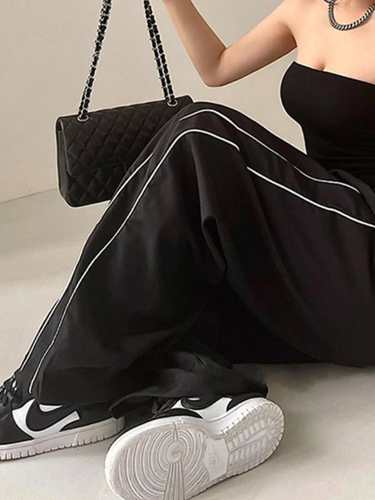 Lightweight women's high-rise wide-leg pants with elastic waist, from Plush Fashion Hub, styled as a casual dress in soft fabric.