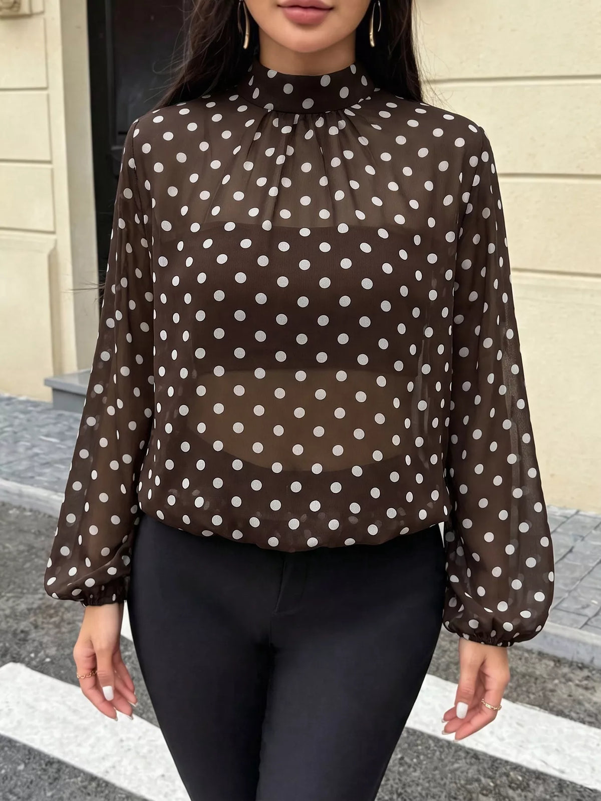Polka dot mock neck long sleeve blouse by Trendsi, featuring a stylish pattern and fitted silhouette, shown in the product image.