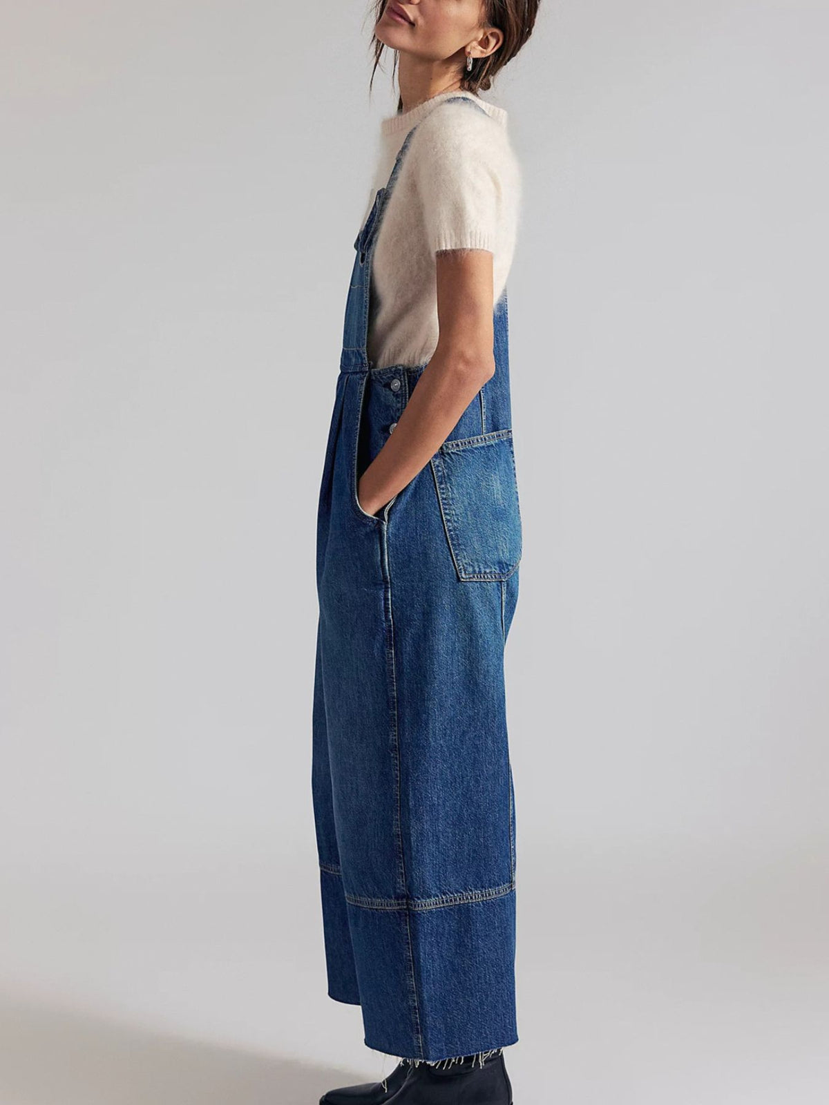 Lightweight casual denim jumpsuit with wide leg and raw hem, featuring adjustable shoulder straps and front pockets by Plush Fashion Hub.