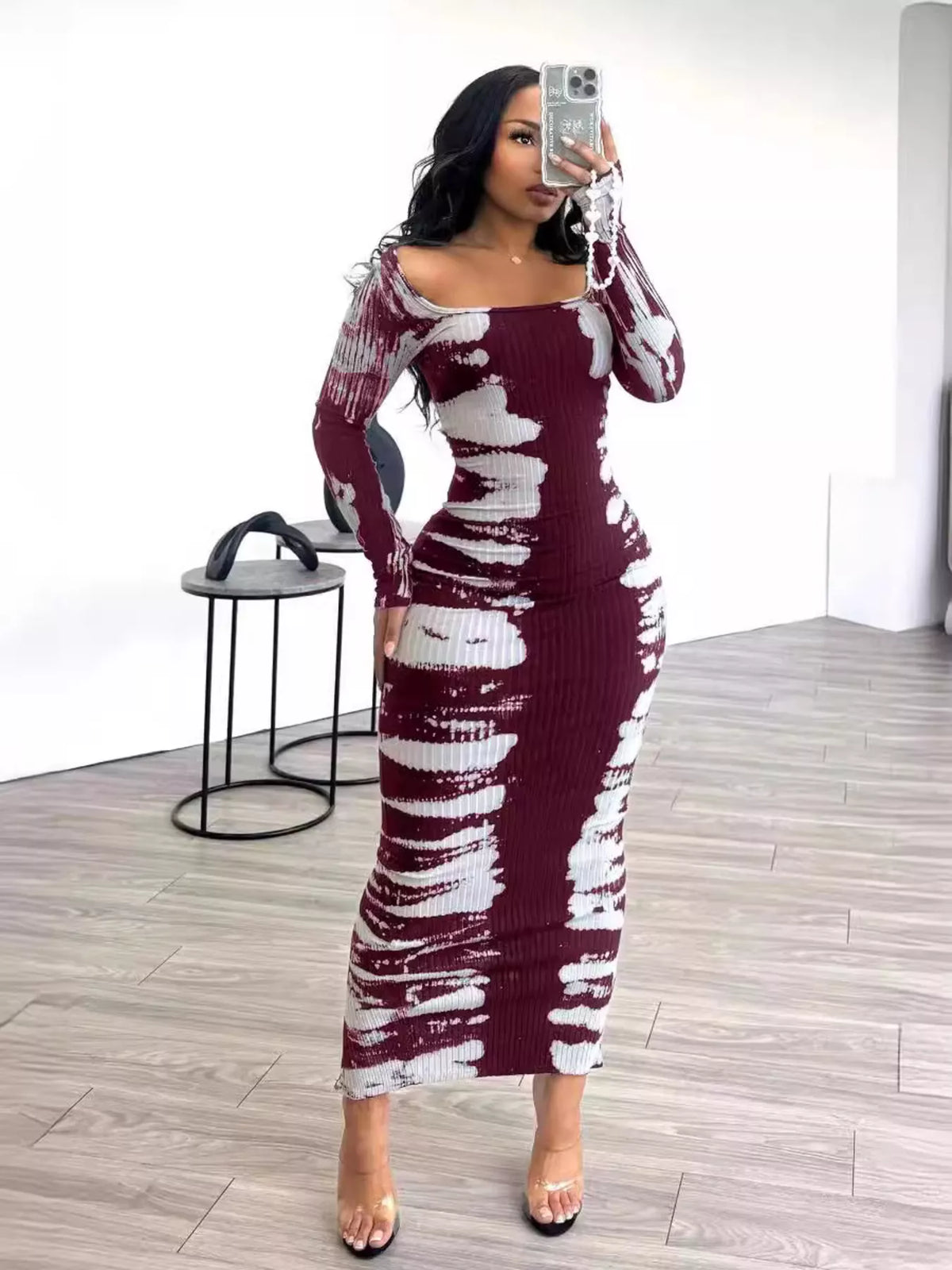 Tie-dye long sleeve maxi dress by Plush Fashion Hub, flowing fabric with vibrant colorful patterns, full-length and stylish.