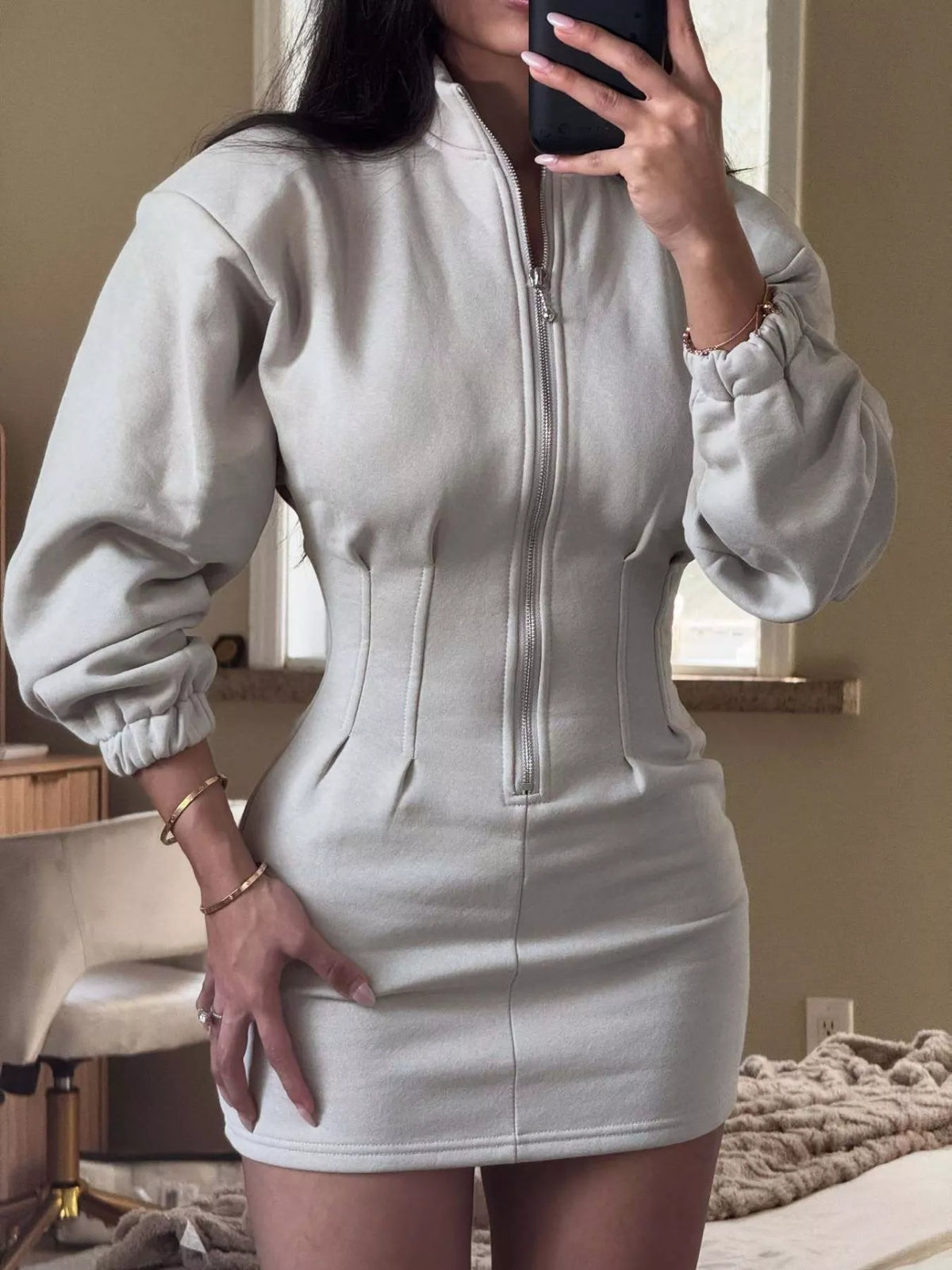 Trendi casual zip-up long sleeve mini dress in soft fabric, featuring a fitted silhouette and stylish design.