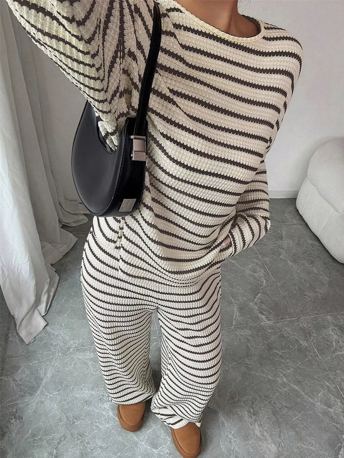 Striped knit dropped shoulder top and pants set by Trendsi, featuring a stylish, cozy matching outfit with bold stripe pattern.