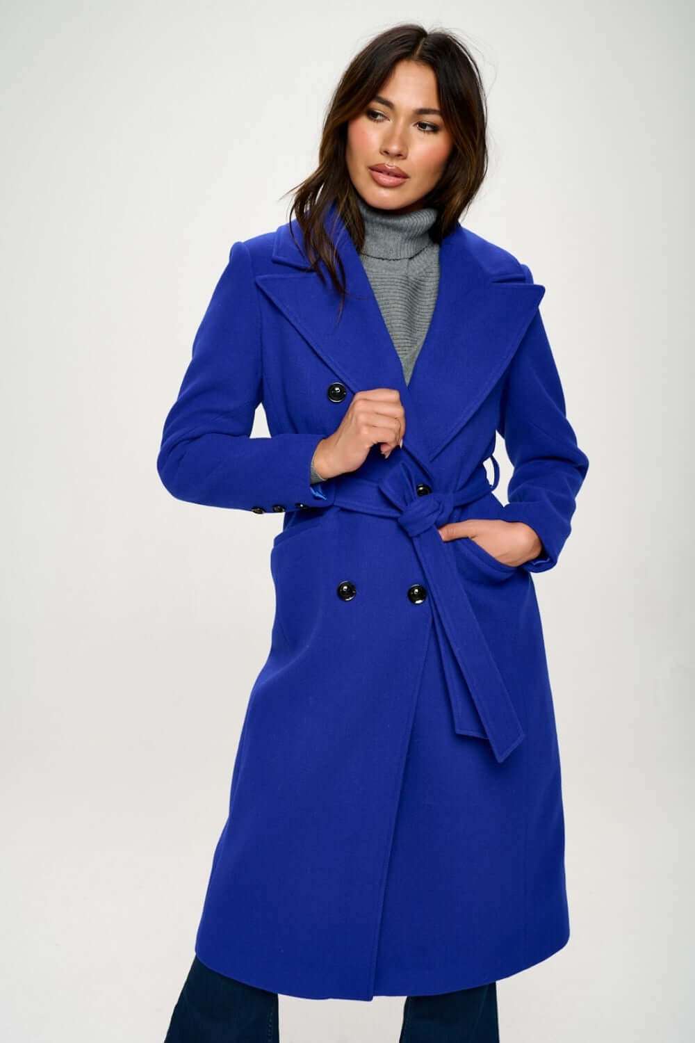 Coalition LA double-breasted longline coat with belt in blue, worn by a model.