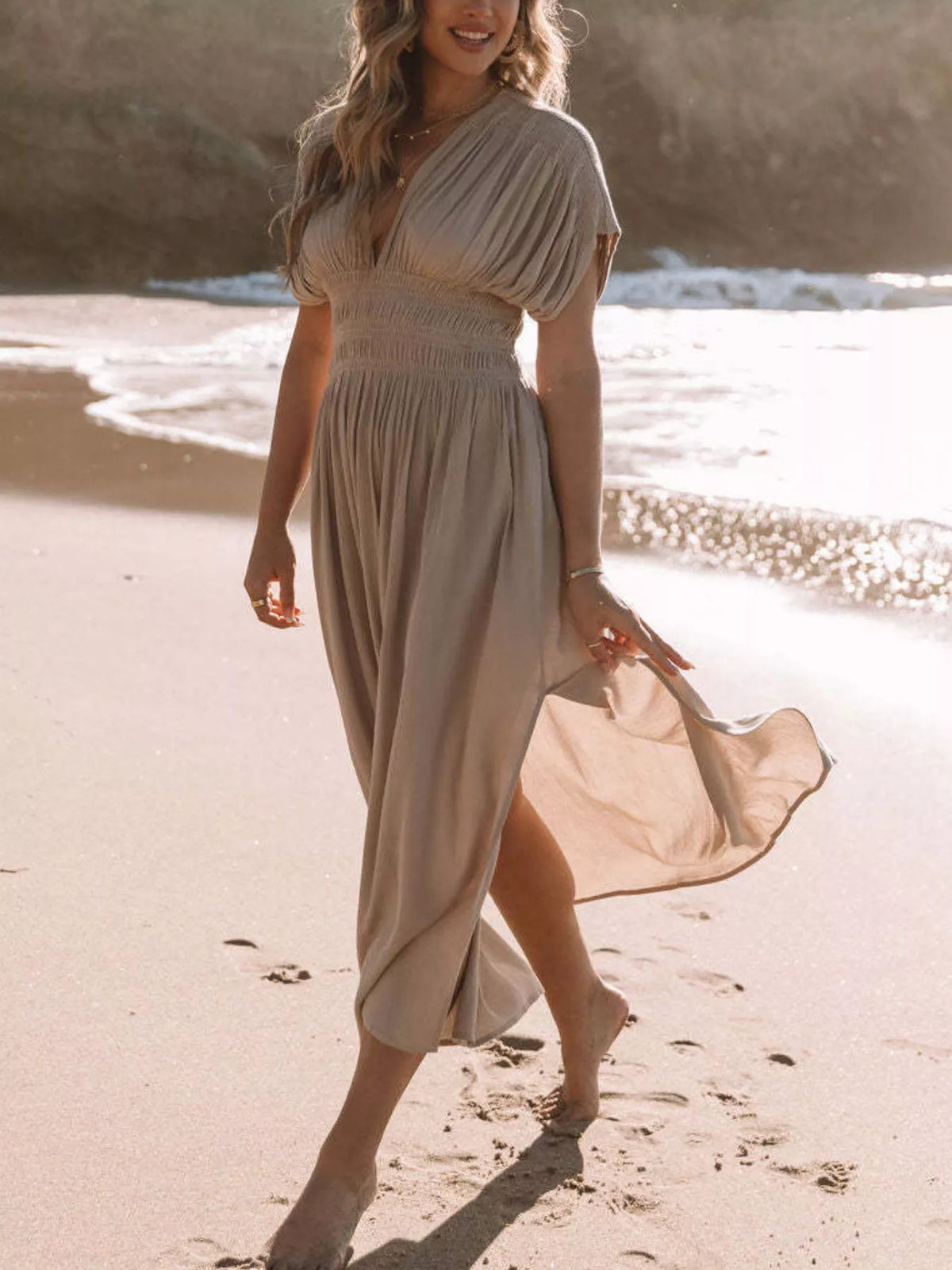 Plus size full slit V-neck maxi dress with smocked waist by Plush Fashion Hub, showing flowing fabric and stylish design.