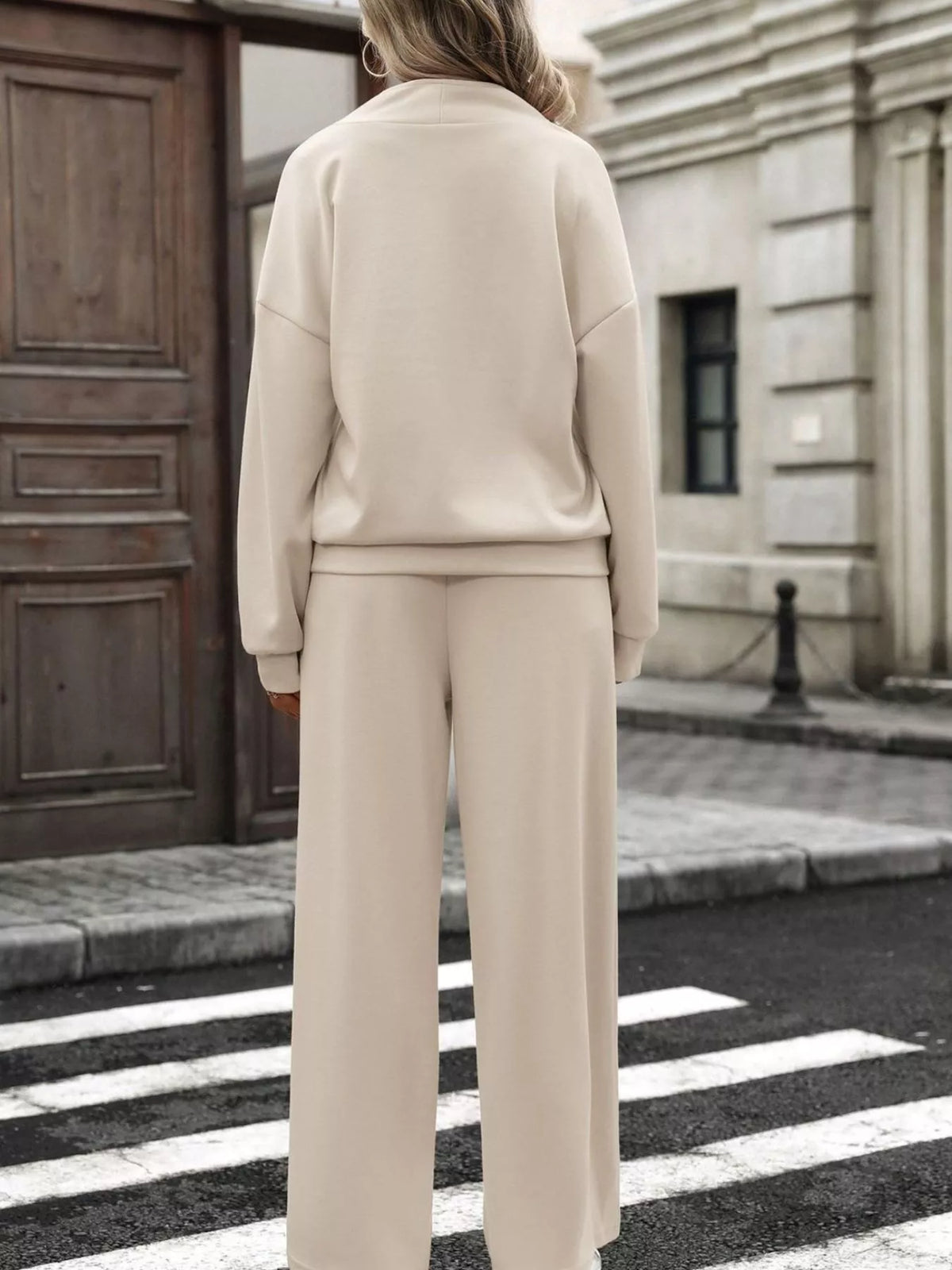 Women’s half zip sweatshirt and wide-leg pants set by Trendsi, featuring a casual, comfortable fit in soft fabric.
