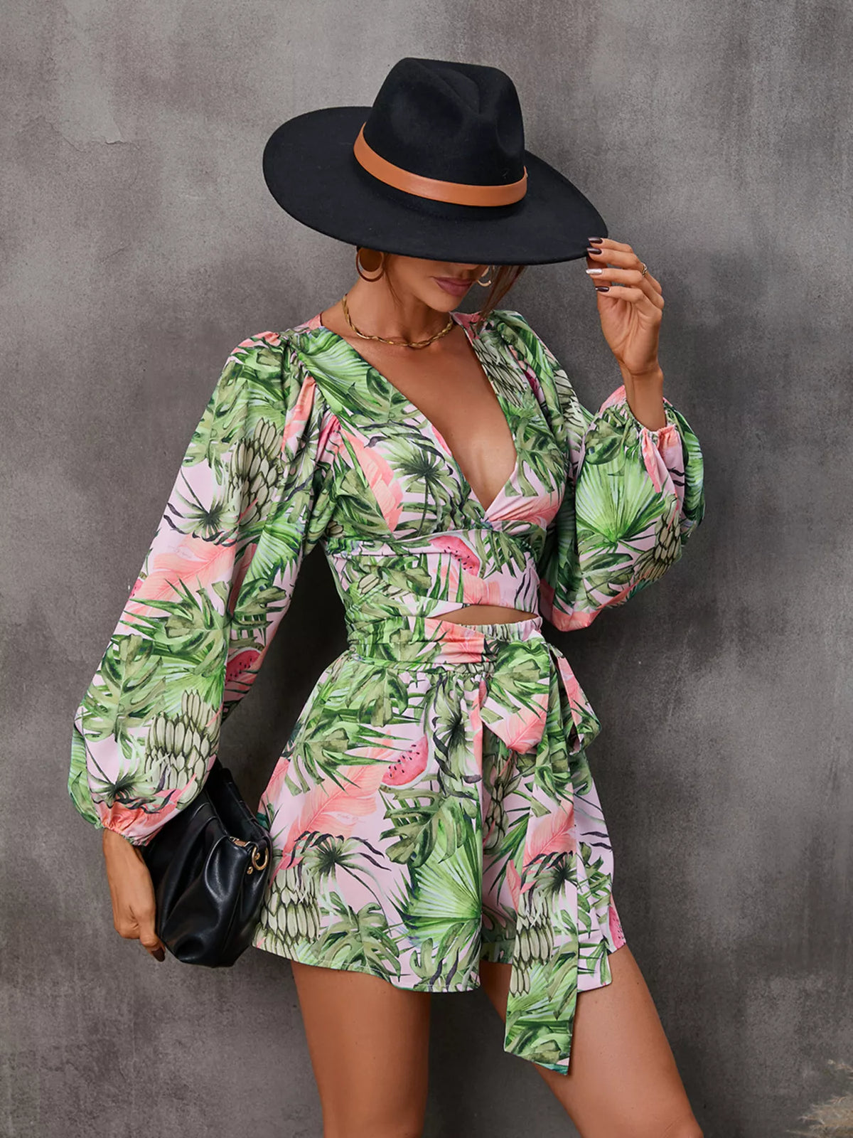 Printed long sleeve romper with cutout front, stylish jumpsuit by Plush Fashion Hub, shown in a fashionable design.