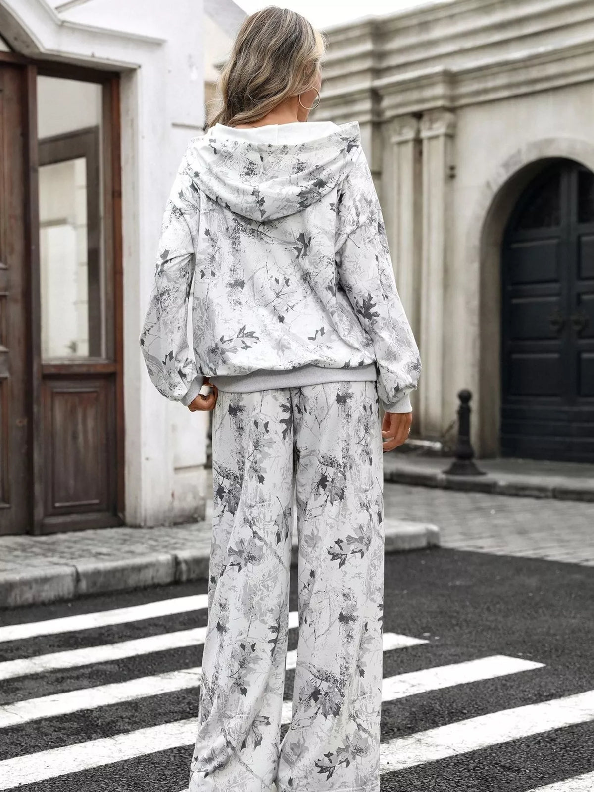 Printed long sleeve hoodie and pants set by Trendsi featuring a stylish design, comfortable fit, and casual loungewear style.