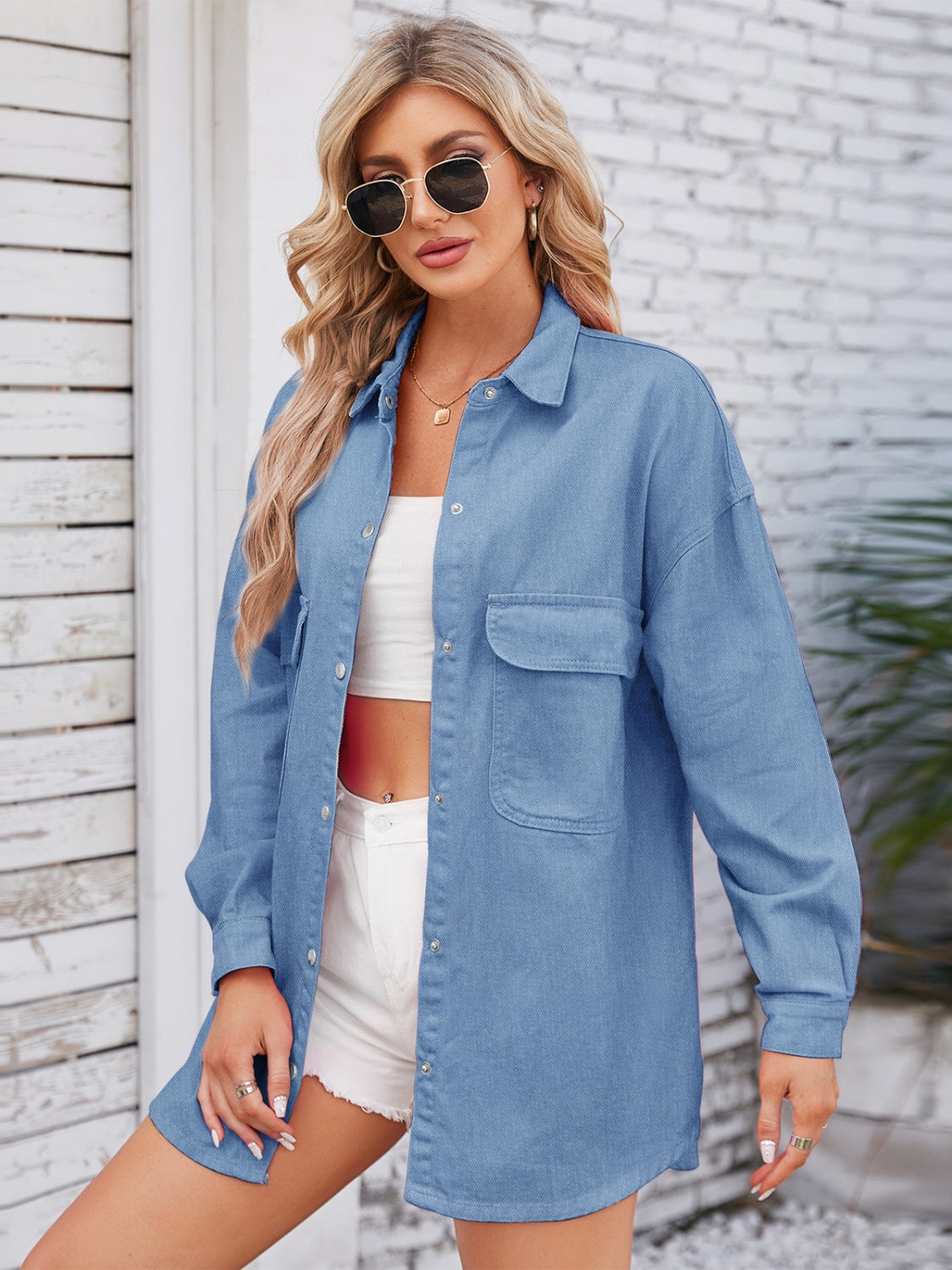 Light blue denim shacket with snap buttons, pocket details, and dropped shoulder design from Plush Fashion Hub's fashion collection.