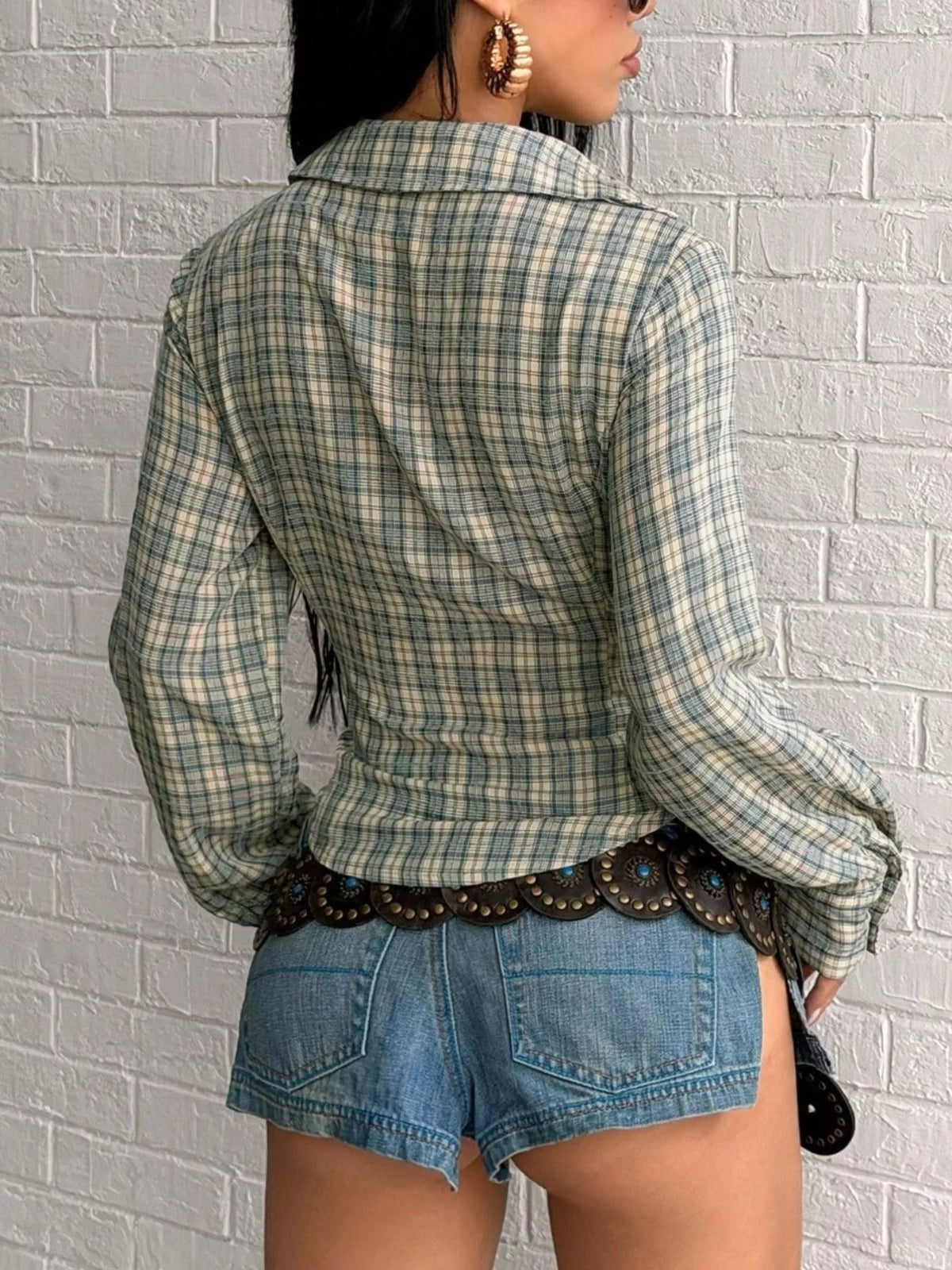 Plaid deep V-neck long sleeve slim fit blouse from Trendsi, featuring a stylish plaid pattern and tailored fit.