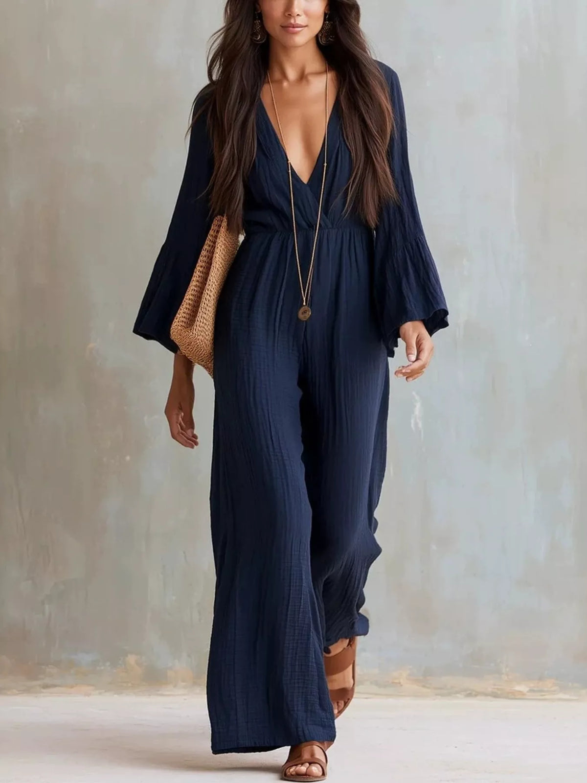 Textured flare sleeve women's jumpsuit by Trendsi, featuring a stylish design with wide flare sleeves and a fitted waist.