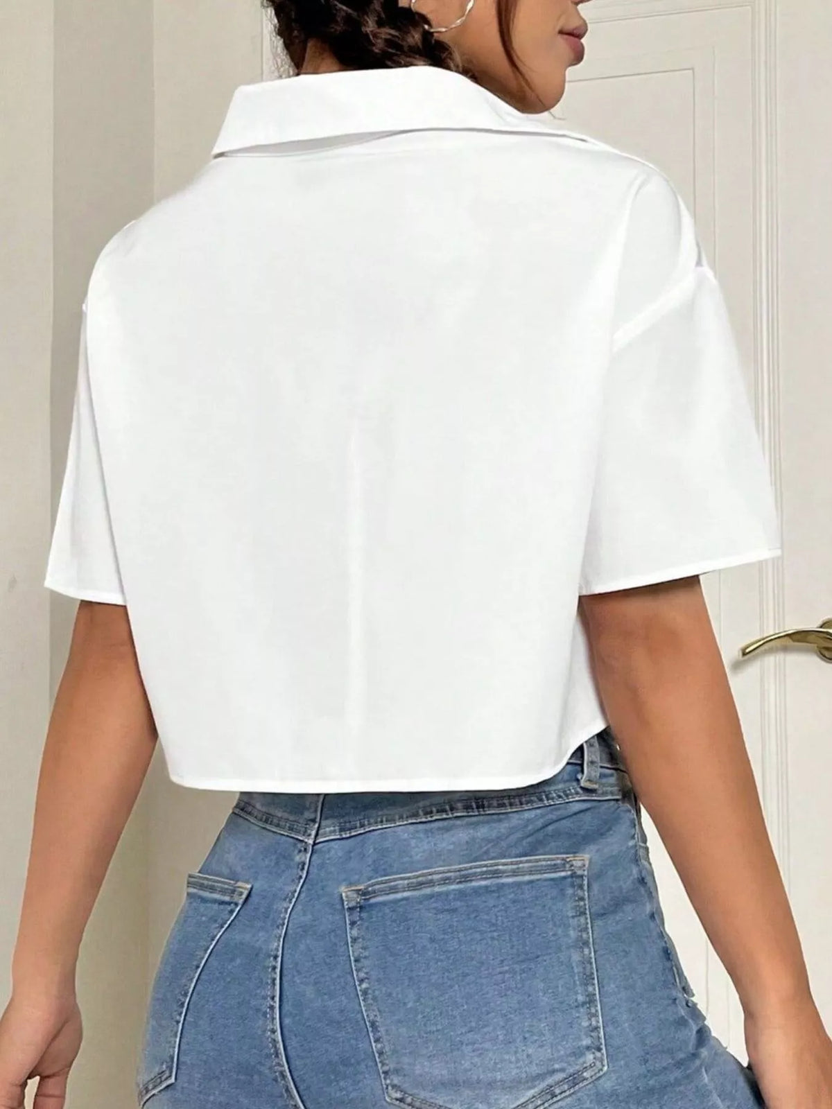 Short sleeve crop shirt with chest pockets, trendy tops by Trendsi, shown in a stylish casual look.