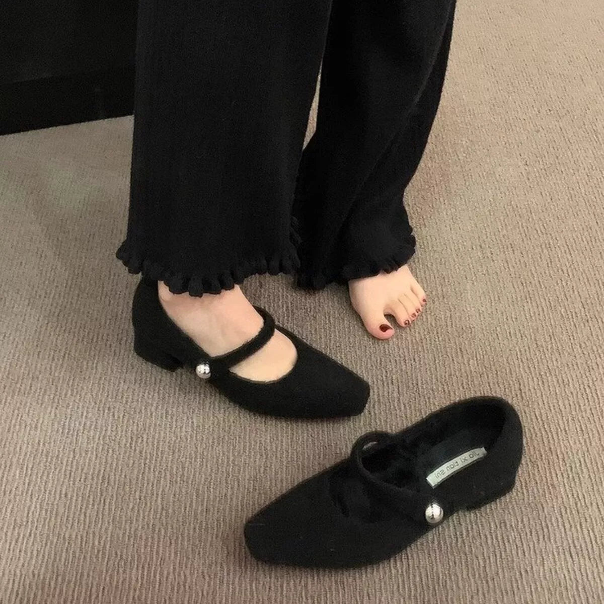 Elegant black block heel loafers from Trendsi with sleek design and tan accents, showcasing stylish shoes on a white background.