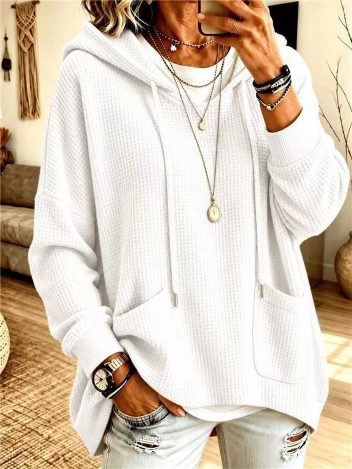 Plus size women's waffle knit hoodie with pockets by Trendsi, featuring a cozy, casual design in a full-size fit.