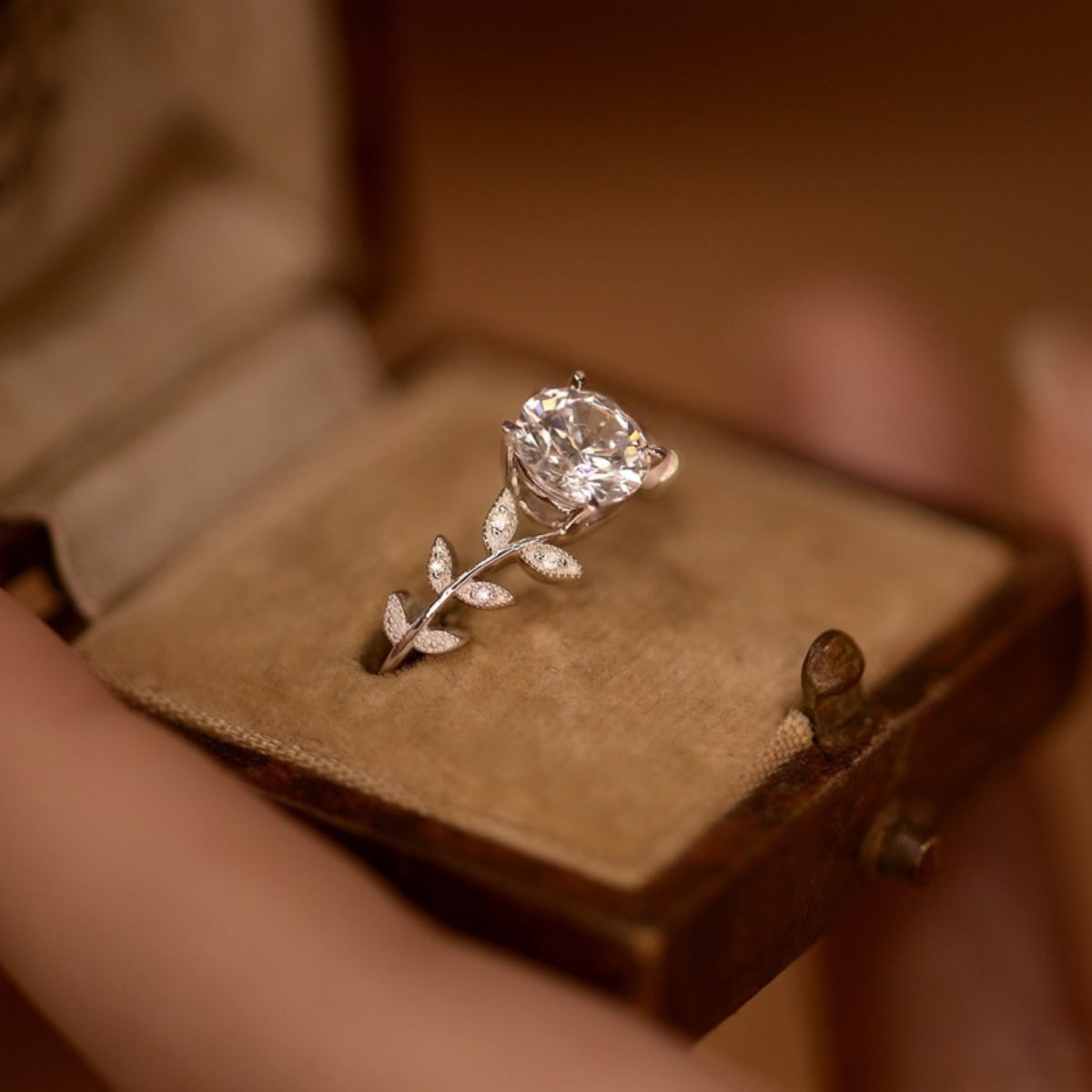 Sterling silver leaf ring with 1-carat moissanite gemstone, showcasing intricate leaf design and sparkling gemstone detail
