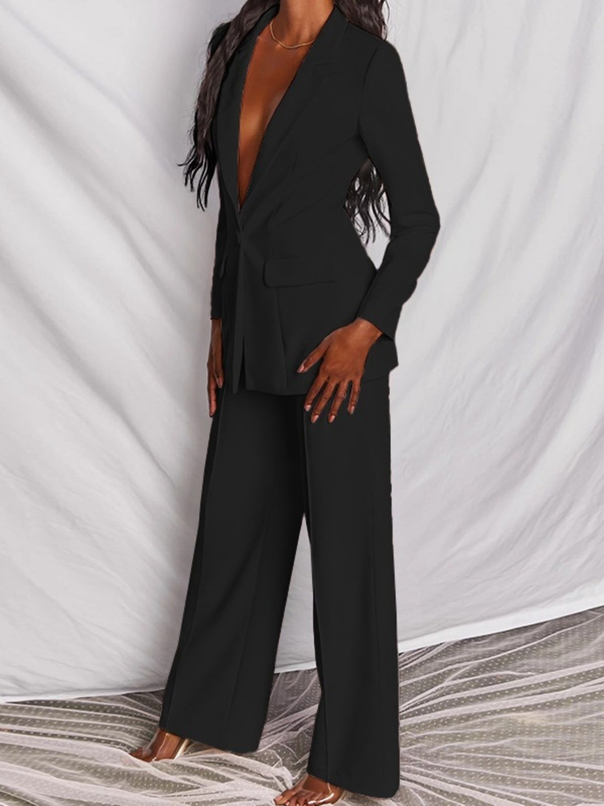 Plus size blazer and wide-leg pants matching set by Trendsi, featuring a one-button blazer and stylish wide-leg trousers.