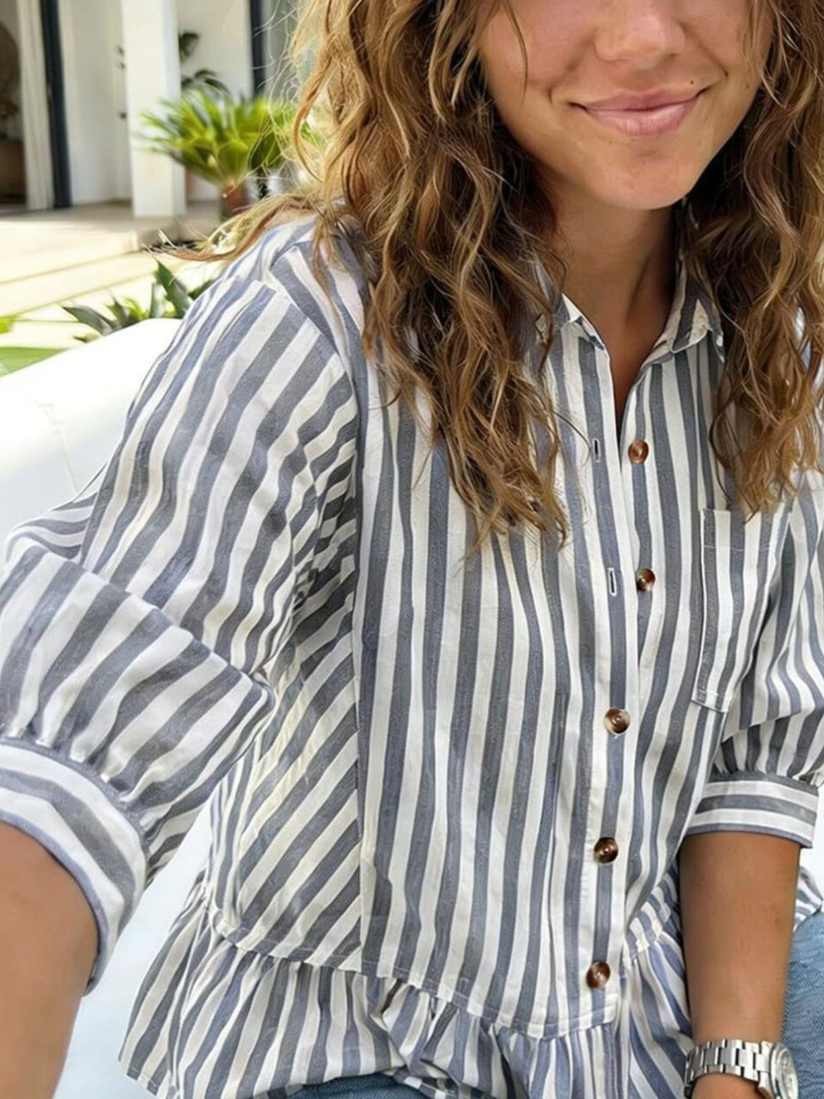 Women’s striped button-down blouse by Plush Fashion Hub with lightweight viscose fabric and ruffled hem detail.