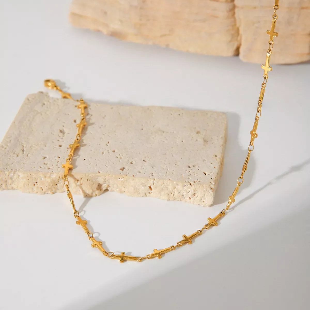 18K gold-plated cross necklace with a sleek chain, stylish jewelry piece from Plush Fashion Hub.