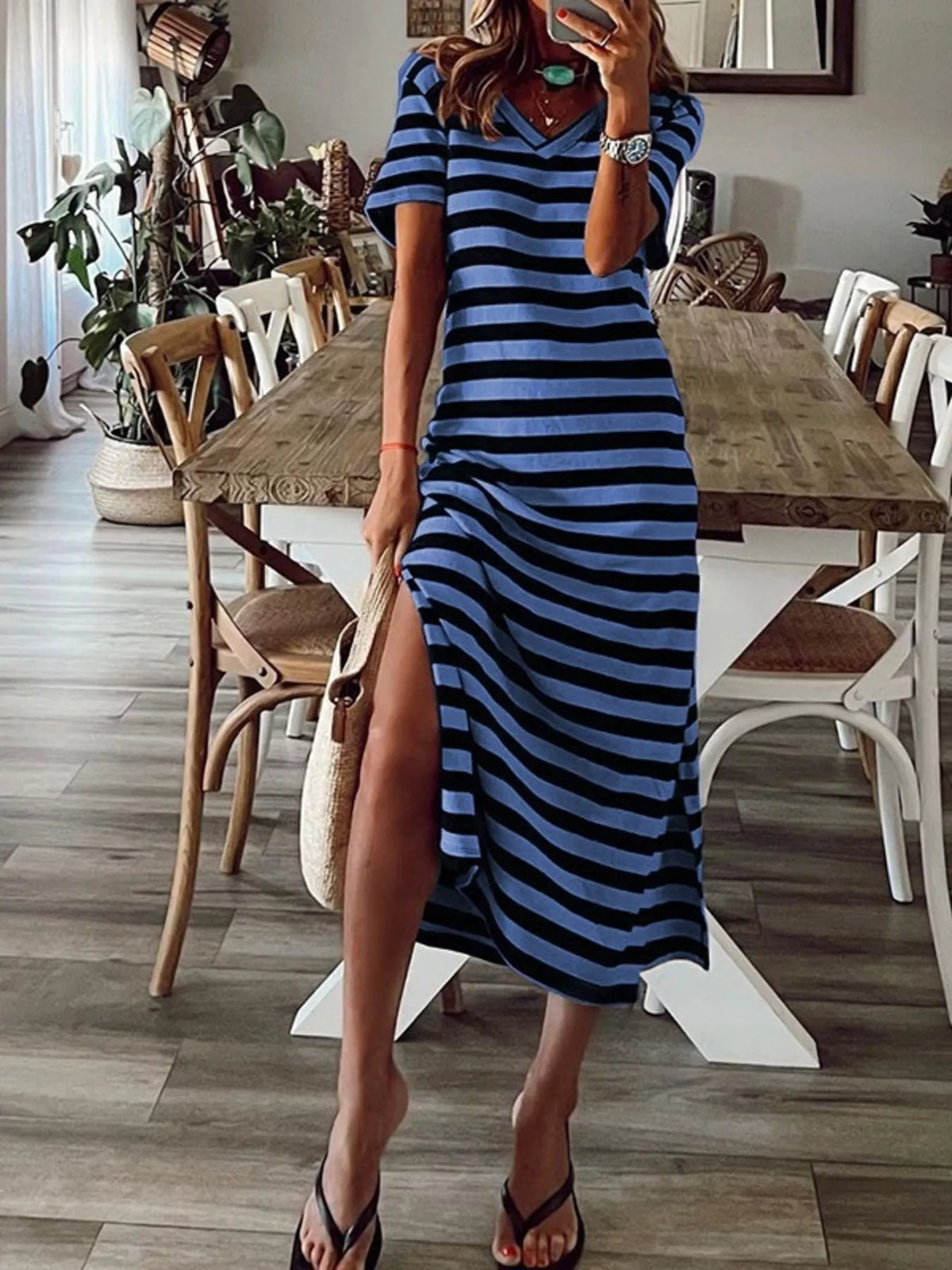 Plus size striped V-neck midi dress with side slit by Trendsi, showcasing a full-length dress with bold stripes and a stylish slit.