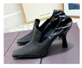 Black leather stiletto mules with a square toe and ruched elasticized collar detail, set on a sculptured heel.