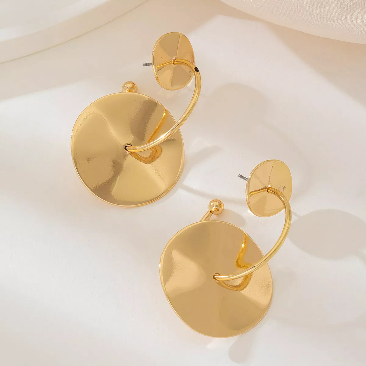 18K gold-plated geometric circle drop earrings with modern design, featuring sleek circular shapes on a plain background
