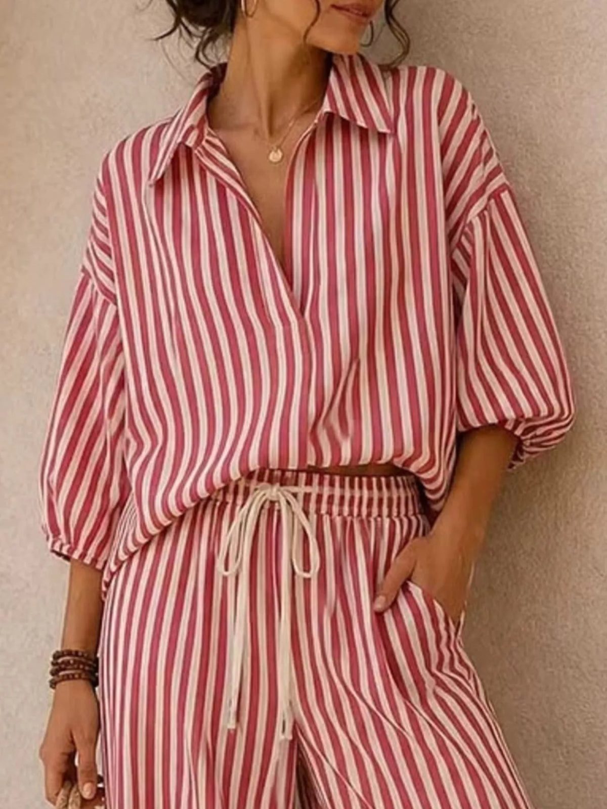 Plus size striped puff sleeve shirt and wide-leg drawstring pants set from Trendsi, featuring a coordinated stylish matching outfit.