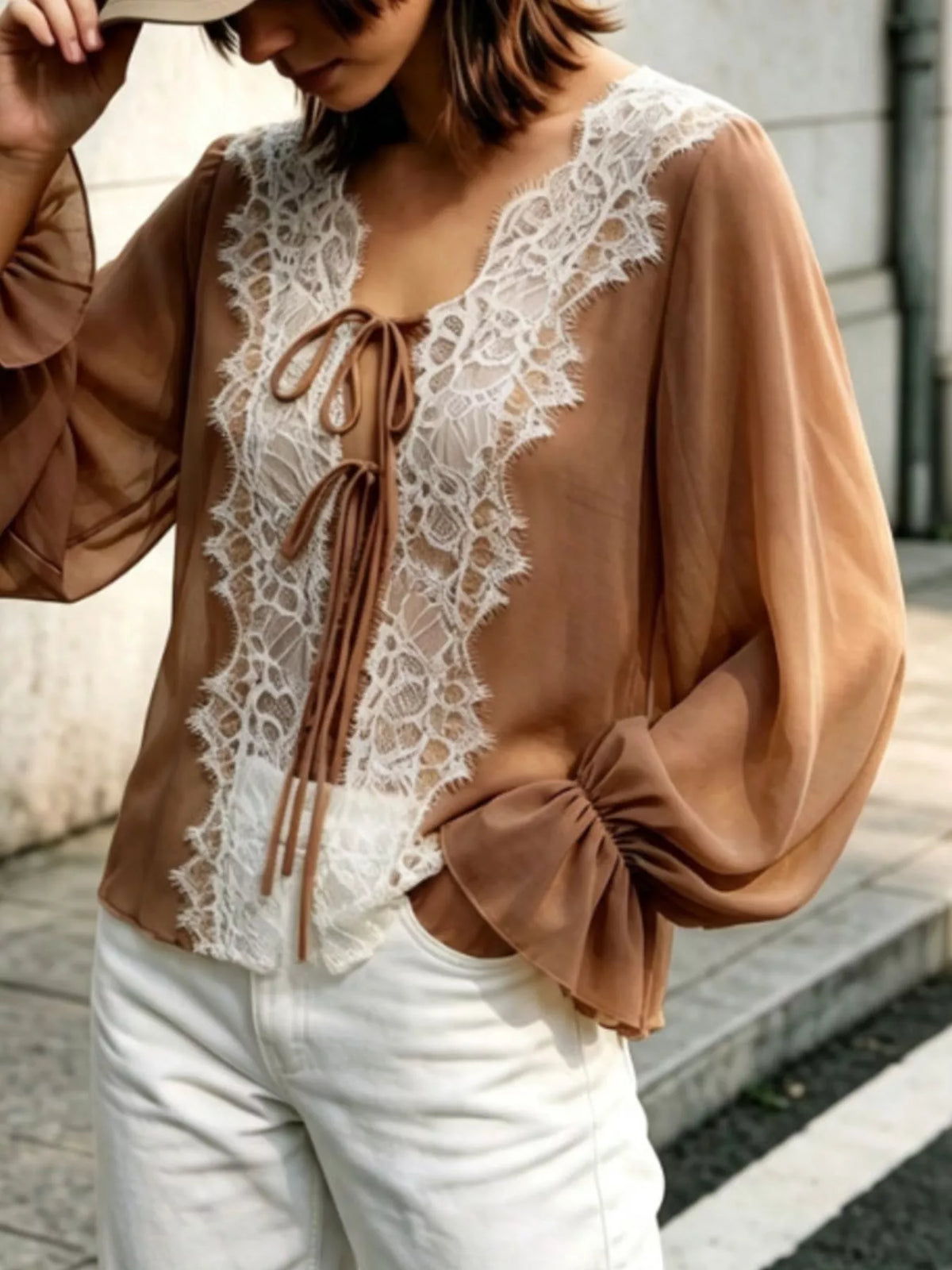 Sheer lace-trimmed front tie blouse for women, featuring lightweight fabric and delicate lace details, perfect for stylish summer wear.