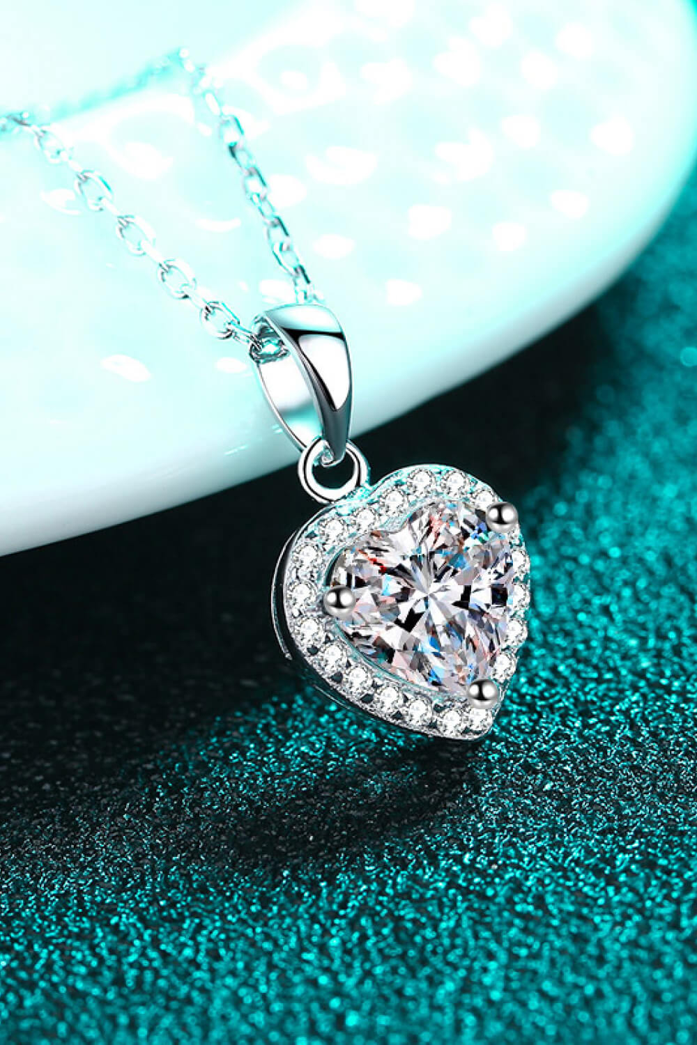 Elegant 1 Carat Moissanite Heart Pendant Necklace with chain, showcasing sparkling gemstone and delicate design from Plush Fashion Hub.