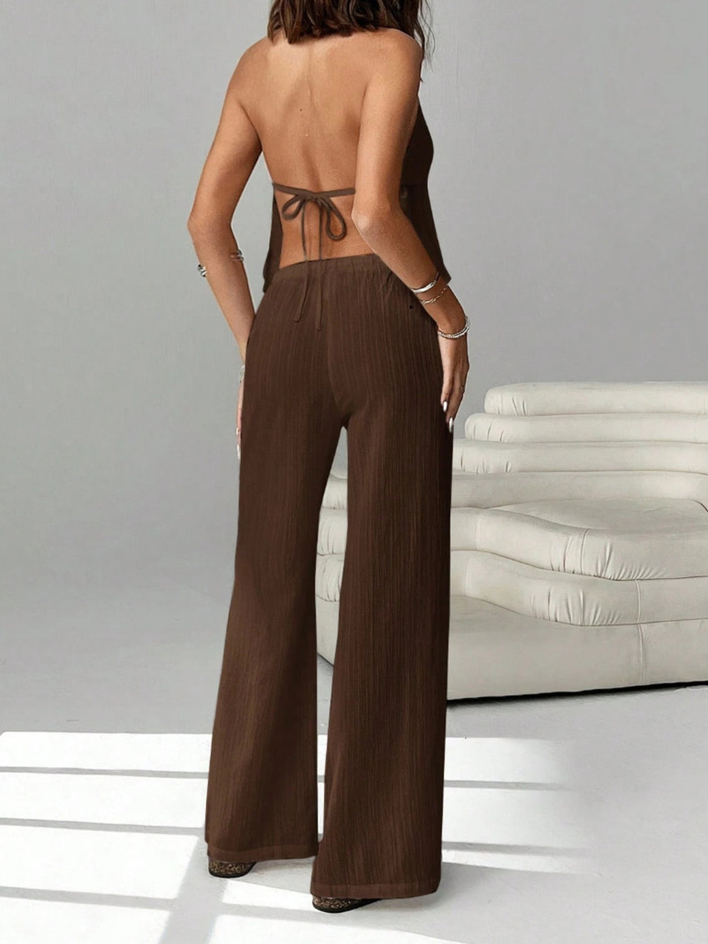 Women's chic halter neck cami and drawstring pants two-piece set by Trendsi, featuring stylish design and comfortable fit.