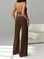 Women's chic halter neck cami and drawstring pants two-piece set by Trendsi, featuring stylish design and comfortable fit.