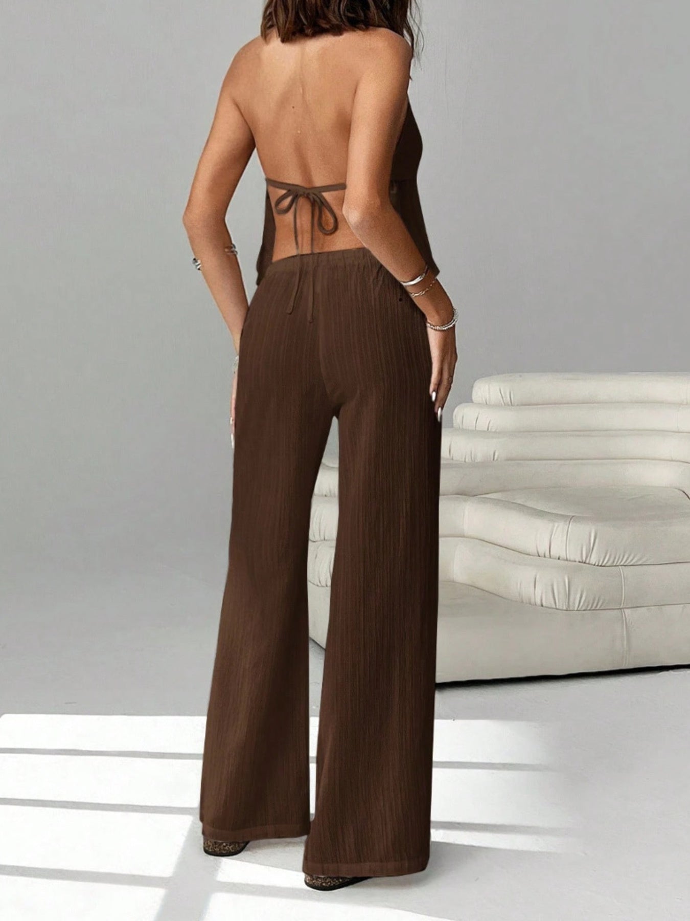 Women's chic halter neck cami and drawstring pants two-piece set by Trendsi, featuring stylish design and comfortable fit.