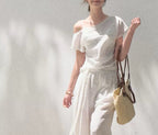 Linen off-shoulder asymmetric casual set by FitiqueFit in two colors, featuring relaxed fit top and matching pants for comfortable style.