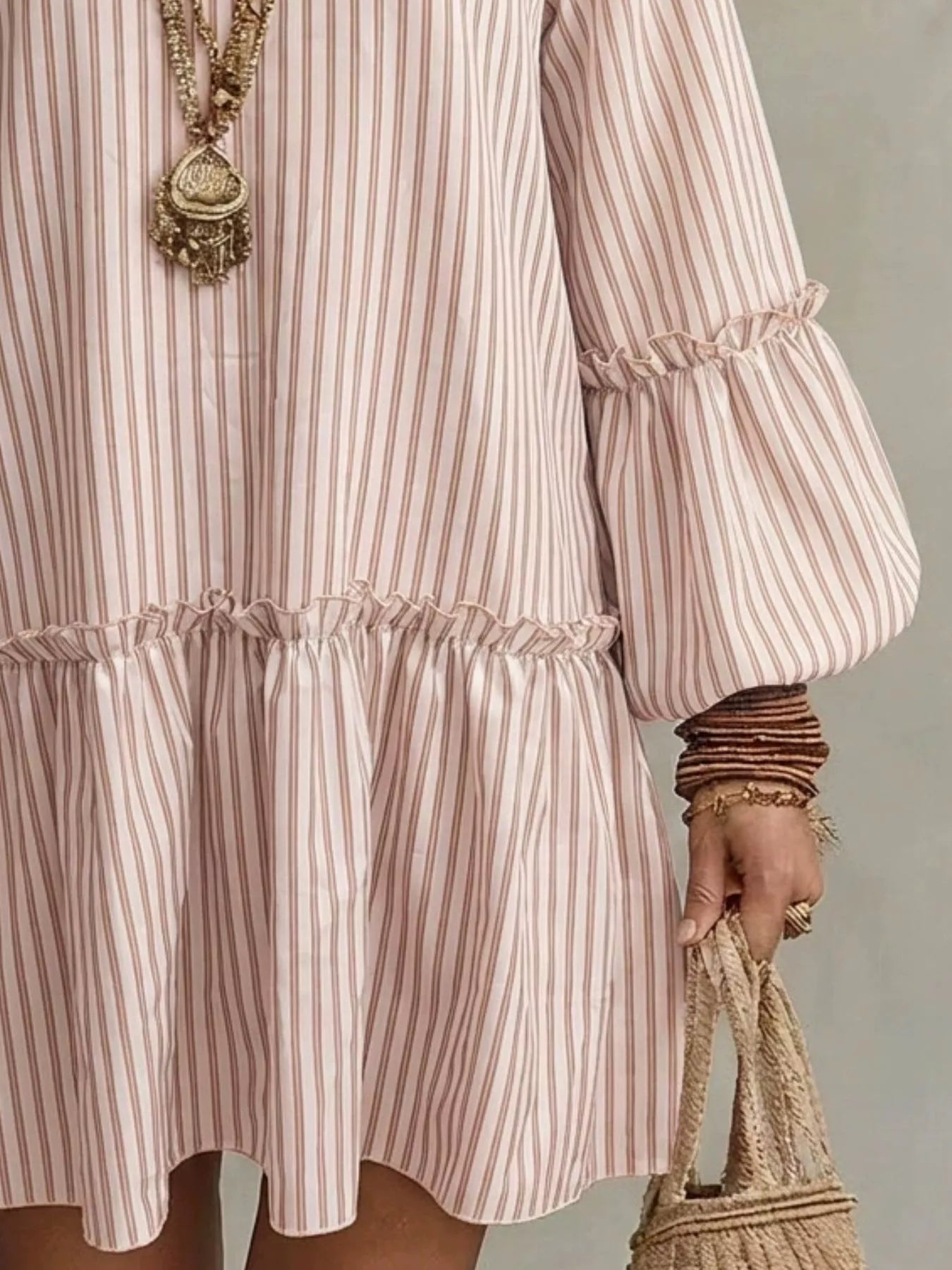 Plus size striped balloon sleeve mini dress by Trendsi, featuring a stylish design with bold stripes and puffed sleeves.