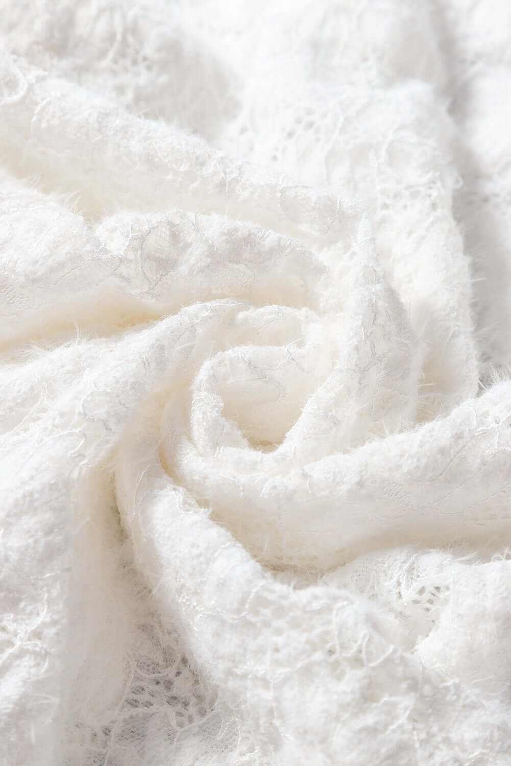 Close-up of white lace fabric for Mock Neck Long Sleeve Lace Top.