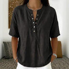 Women's solid color loose-fit short-sleeve pullover top by FitiqueFit, casualwear style, shown in a relaxed fit on a model.
