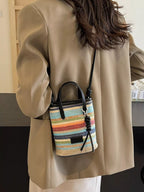 Striped woven mini crossbody bag with adjustable strap and colorful pattern, trendy accessory from Trendsi.