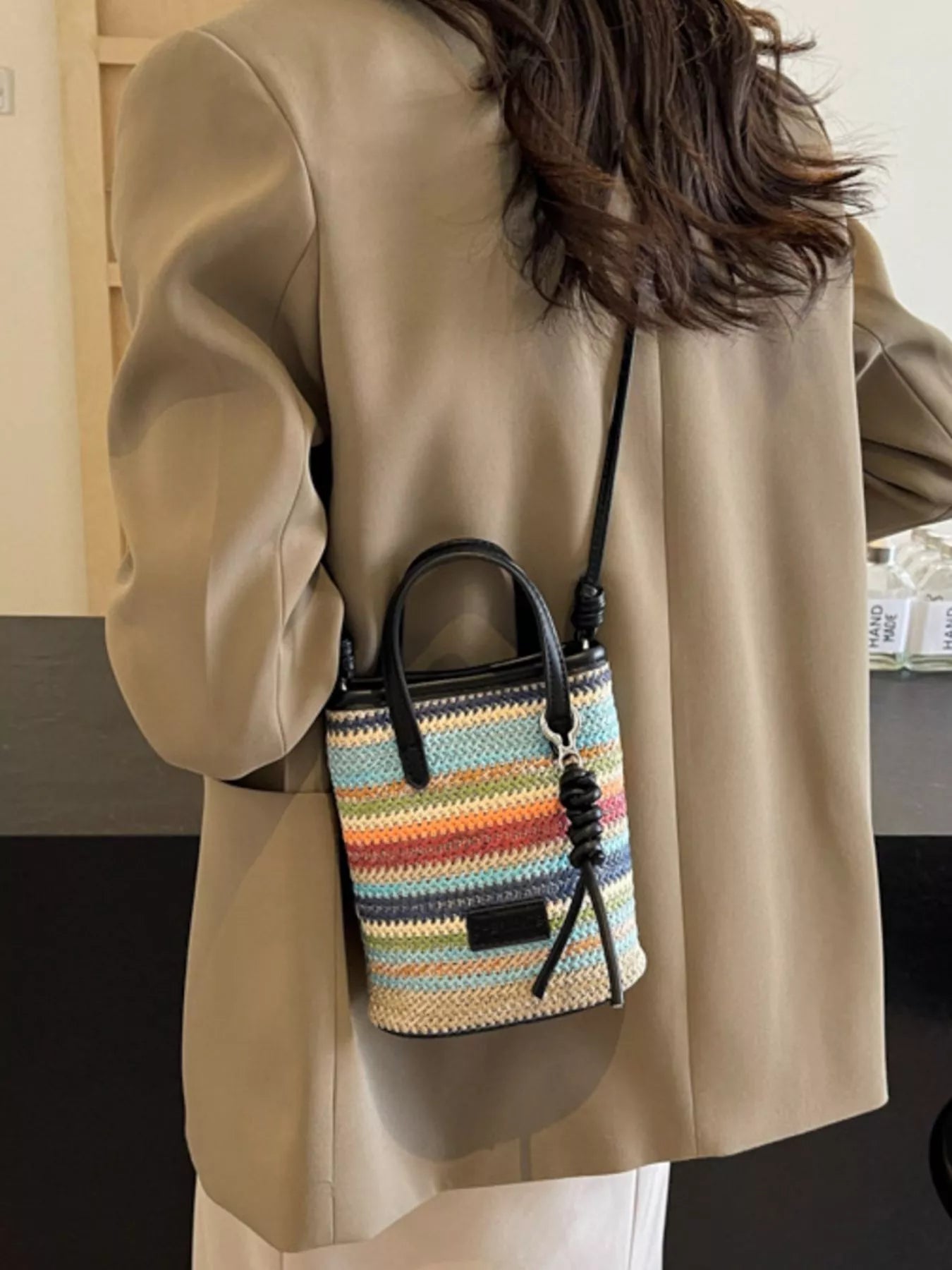 Striped woven mini crossbody bag with adjustable strap and colorful pattern, trendy accessory from Trendsi.