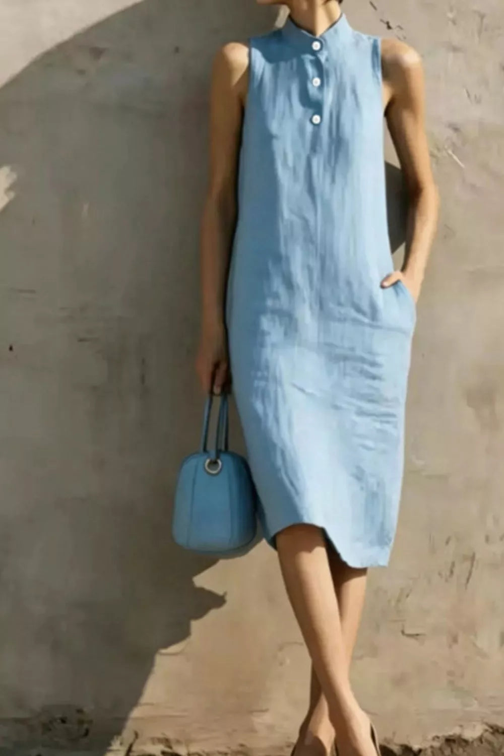 Casual sleeveless midi dress with button details from Plush Fashion Hub, featuring a relaxed fit and stylish design.