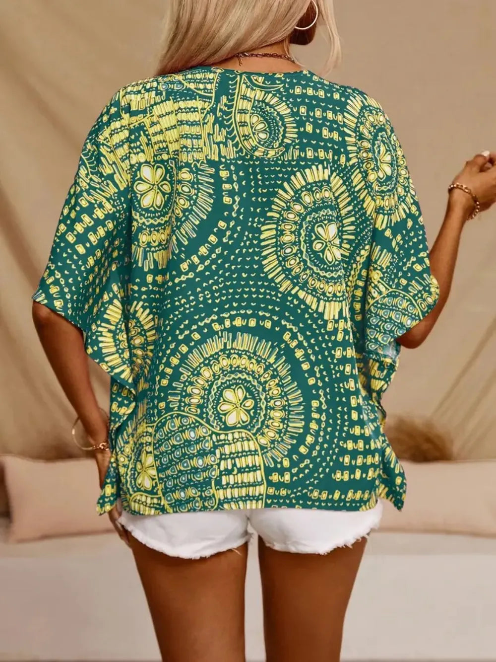 Women's printed V-neck half sleeve blouse by Plush Fashion Hub, soft stretch casual office top with stylish pattern.