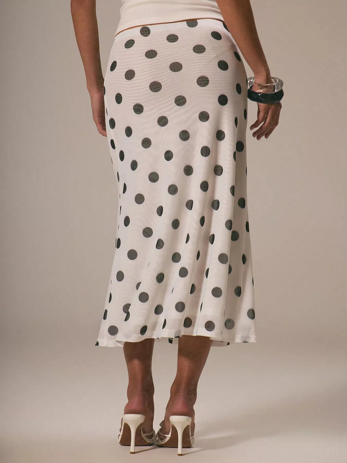 Women's polka dot midi skirt by Plush Fashion Hub, vintage-inspired high-waisted A-line skirt with classic polka dot pattern.