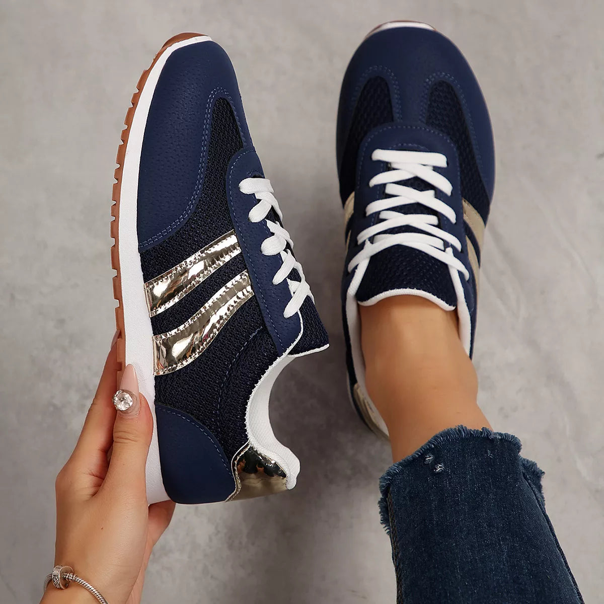 Women's round toe lace-up sneakers by Trendsi featuring classic design and comfortable fit, shown in a stylish casual setting.