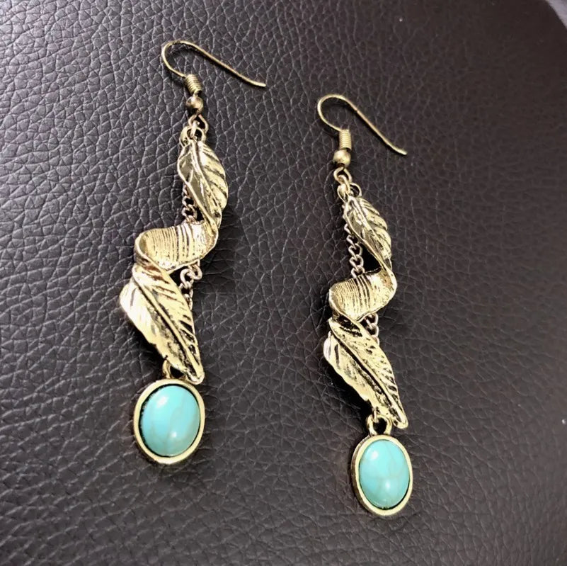 Turquoise alloy leaf earrings from Plush Fashion Hub featuring elegant leaf-shaped design and vibrant blue color.