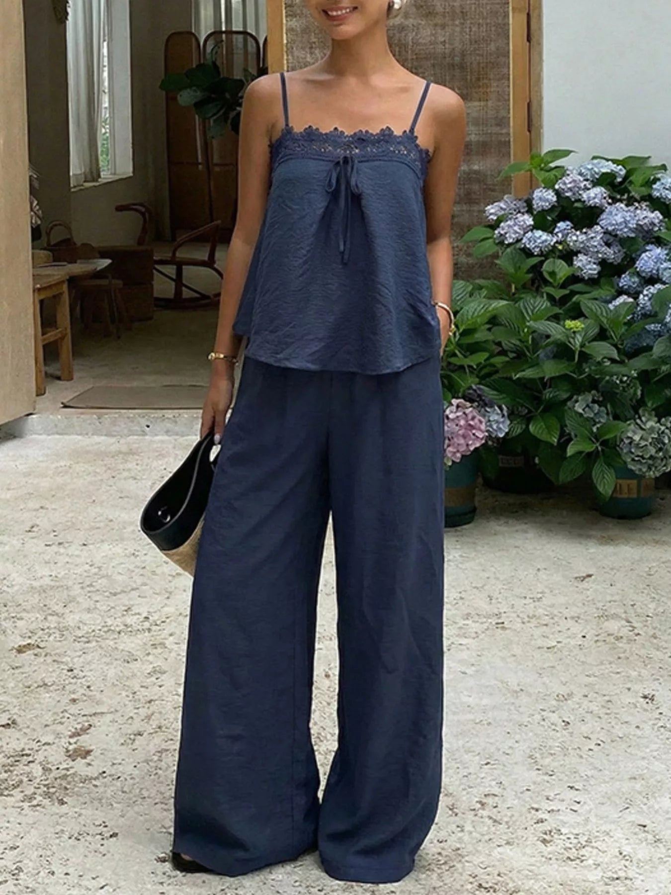 Lace trim camisole and wide-leg pants set by Trendsi, featuring delicate lace details and a flowing, stylish silhouette.