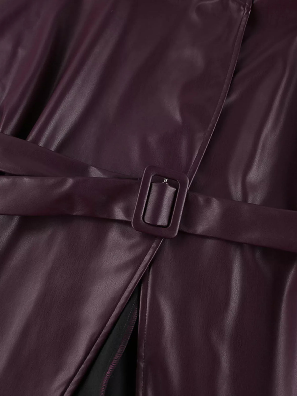 Women's faux leather jacket with stand collar and belt, stylish trendy jacket by Trendsi, shown in a front view.