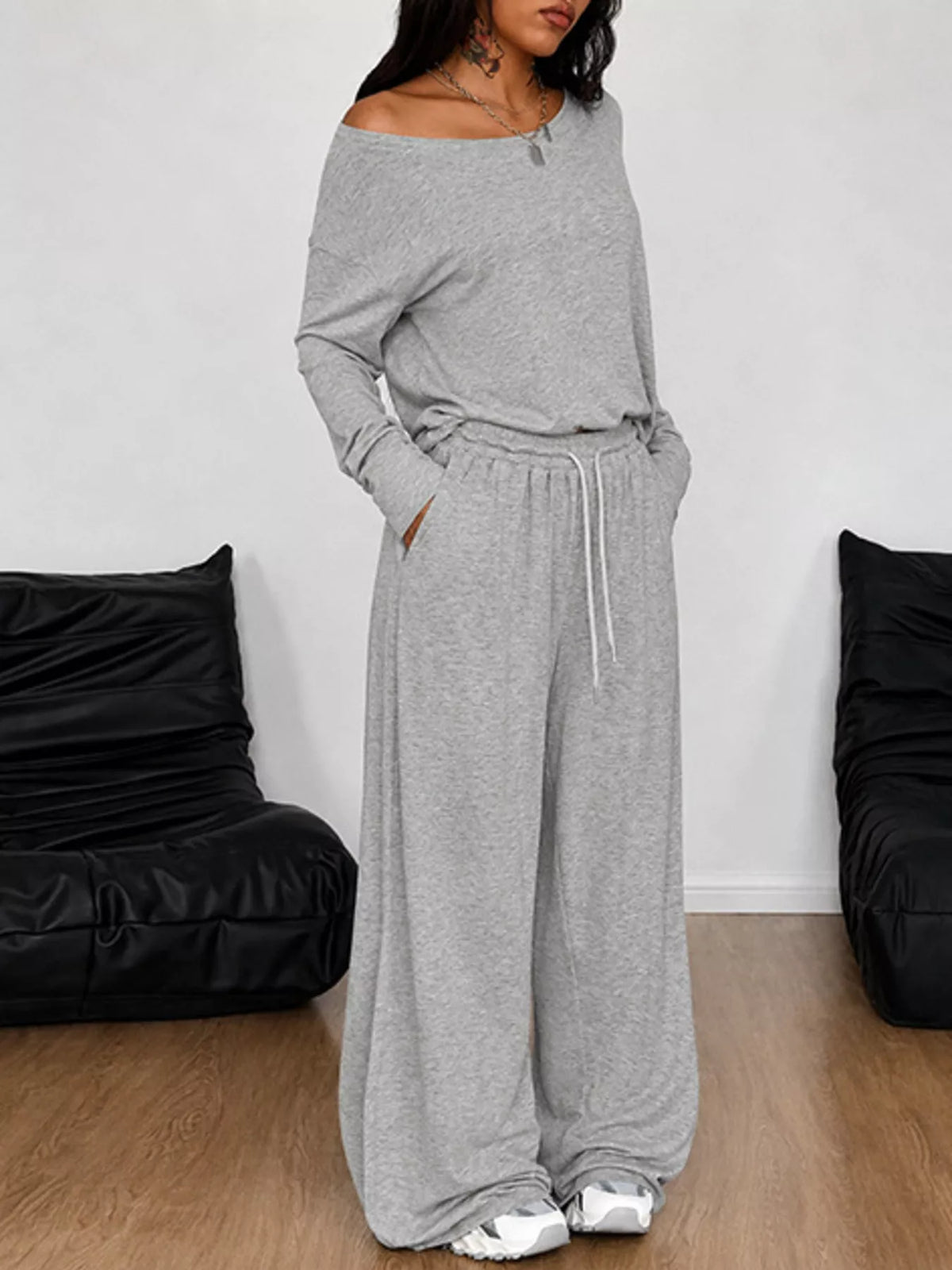 Plus size loose fit one-shoulder T-shirt and pants matching set by Trendsi, featuring a relaxed fit and stylish design.